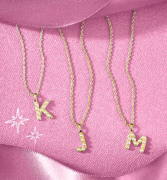Image of three gold initial necklaces