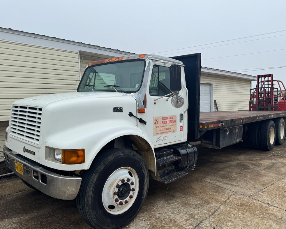 Delivery trucks at Booneville Lumber Company
