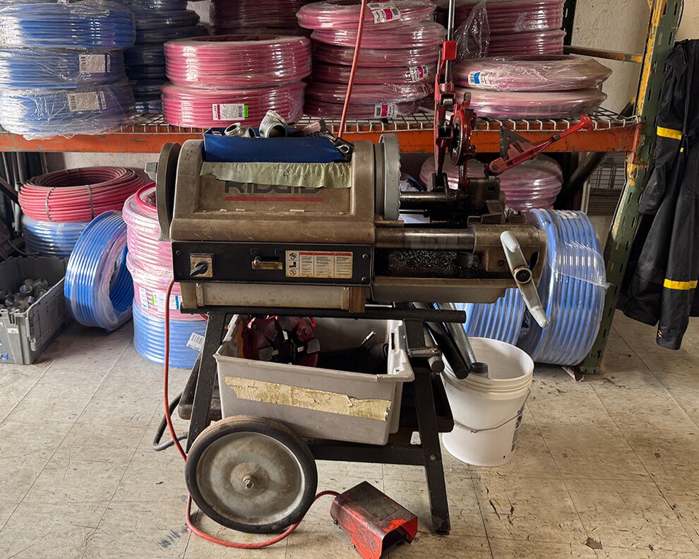 Cutting and threading machine for electrical conduit pipes.