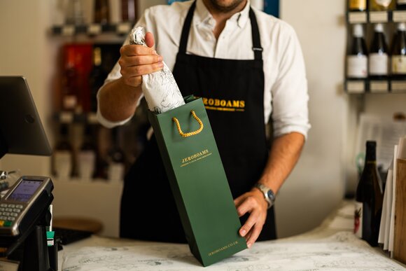 Bottle of Kopke White Port On Ice alongside a chilled glass of white port served over ice