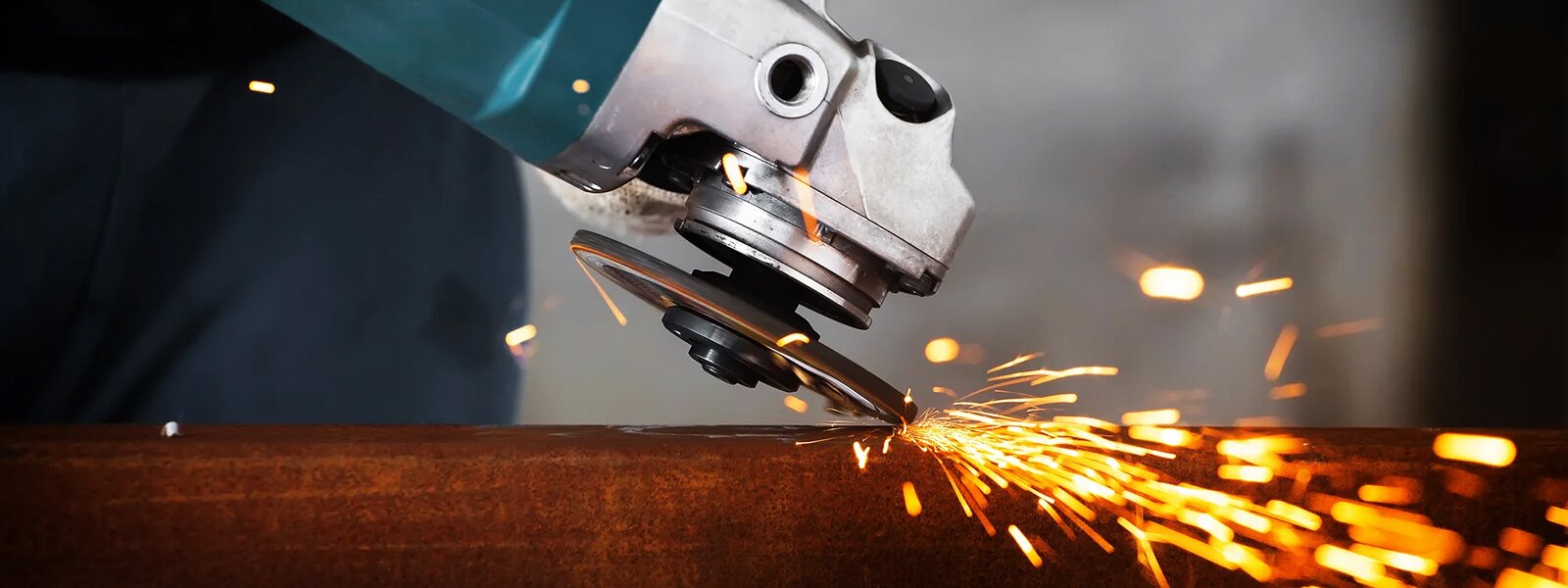 worker using circular saw to cut metal