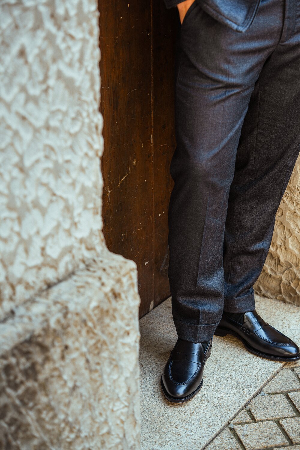 A man standing wearing a pair of black calf loafers.