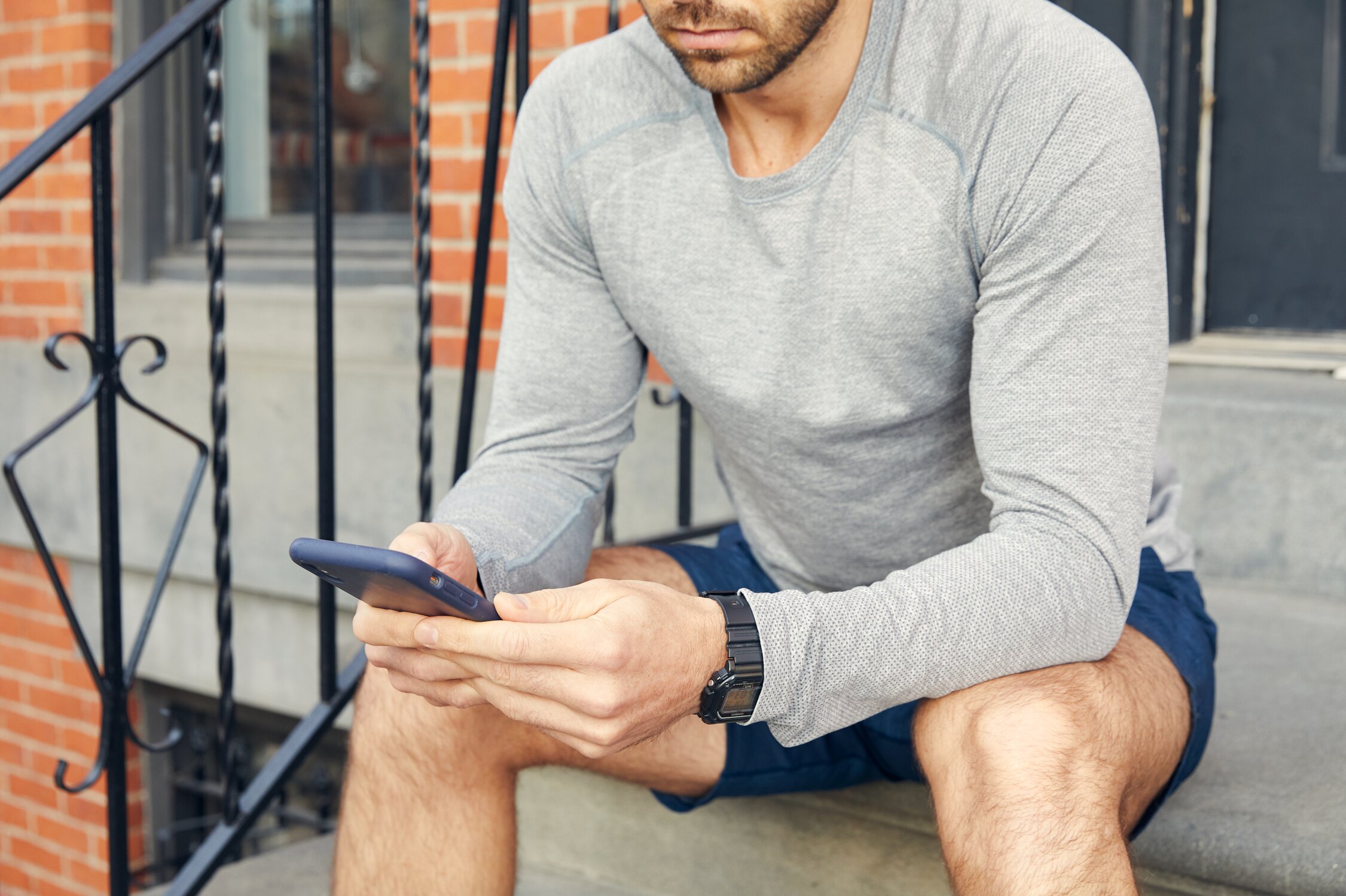 Man in athletic wear looking at phone