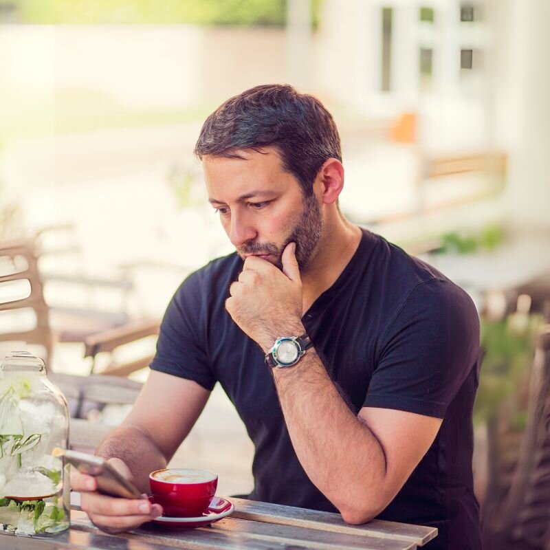 Man checking his Scansurance Plus account on his phone to review what he has at home using previously captured visual scans.