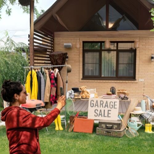 Person scanning their garage sale setup with the Scansurance app to create a visual inventory of displayed items and track what’s been sold.