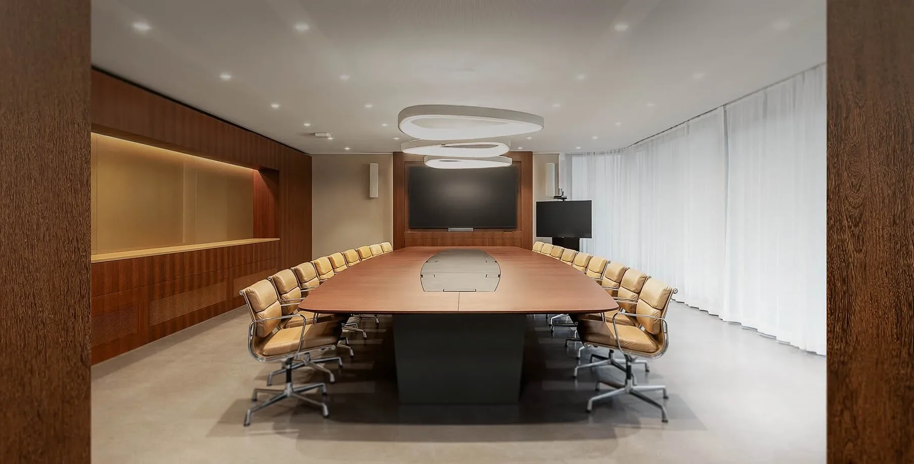 Conference room with large table and chairs, suitable for meetings and strategic planning.