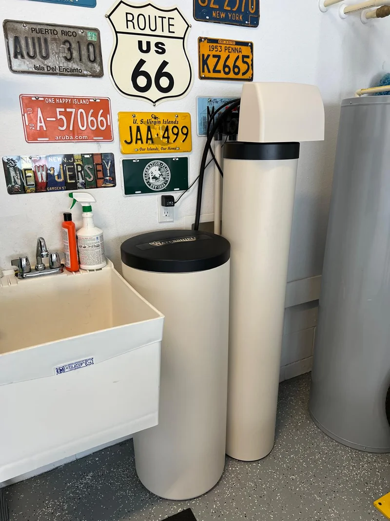 Water softening and filtration equipment installed in a utility room