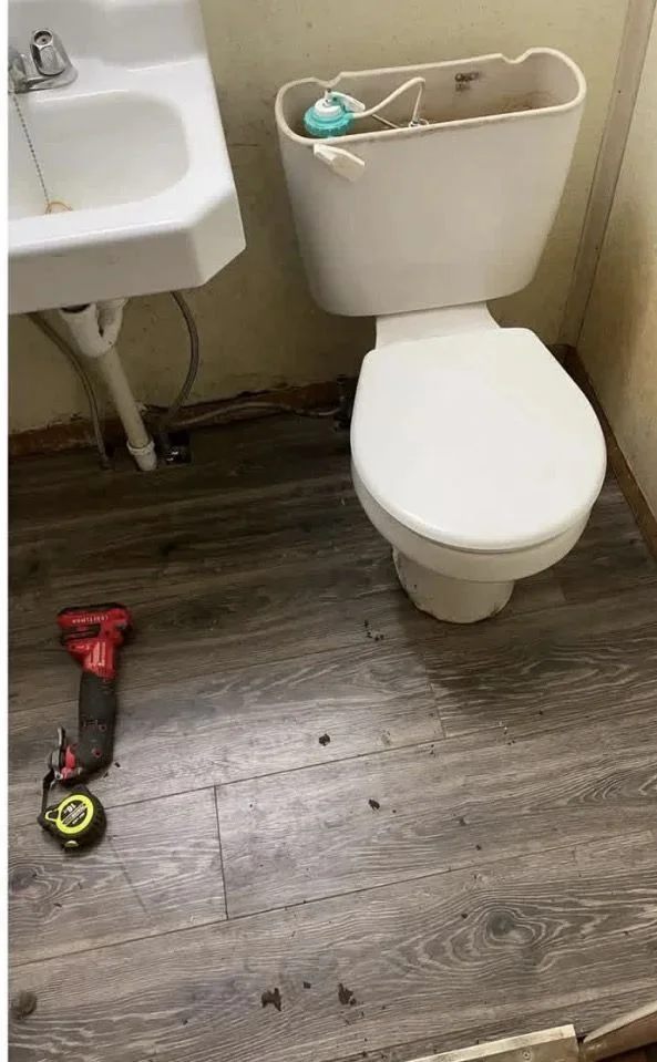 Bathroom with repaired flooring and fixtures