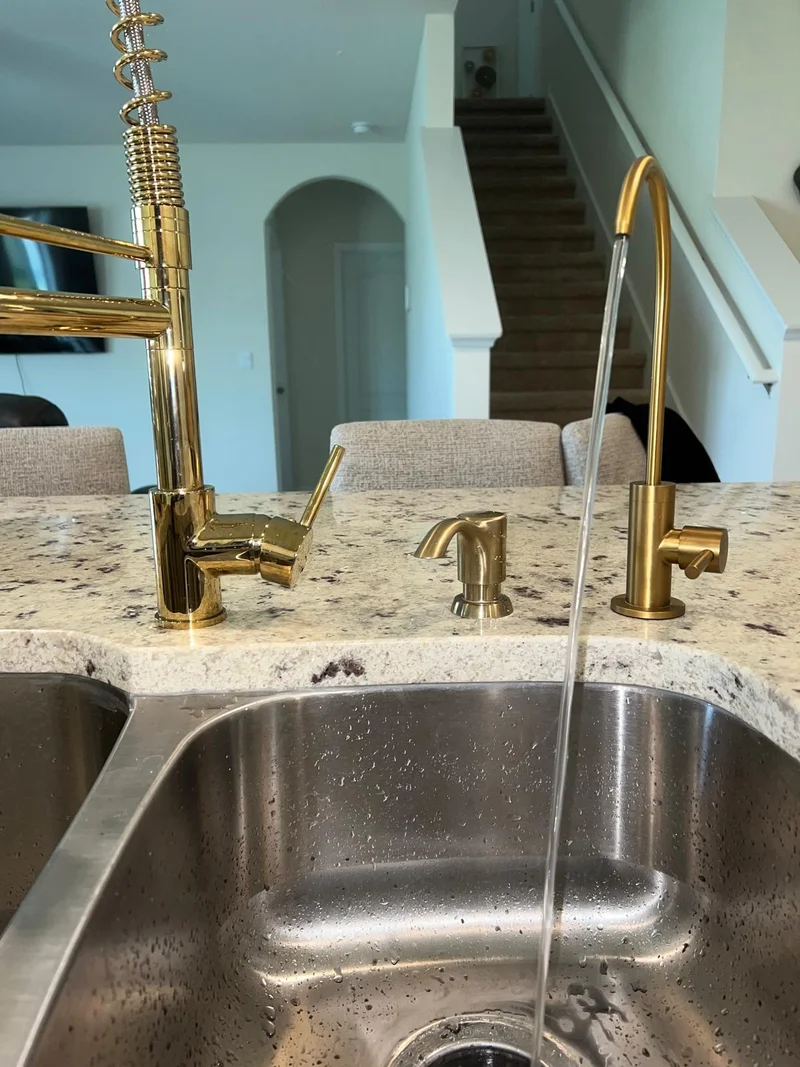 Clean filtered water flowing from a dedicated drinking water faucet