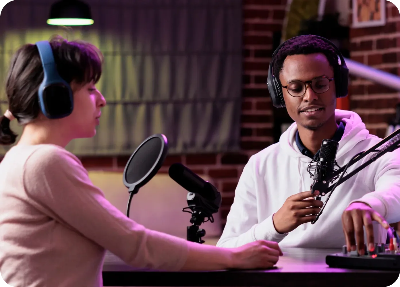 A female and male having a conversation in a podcast studio