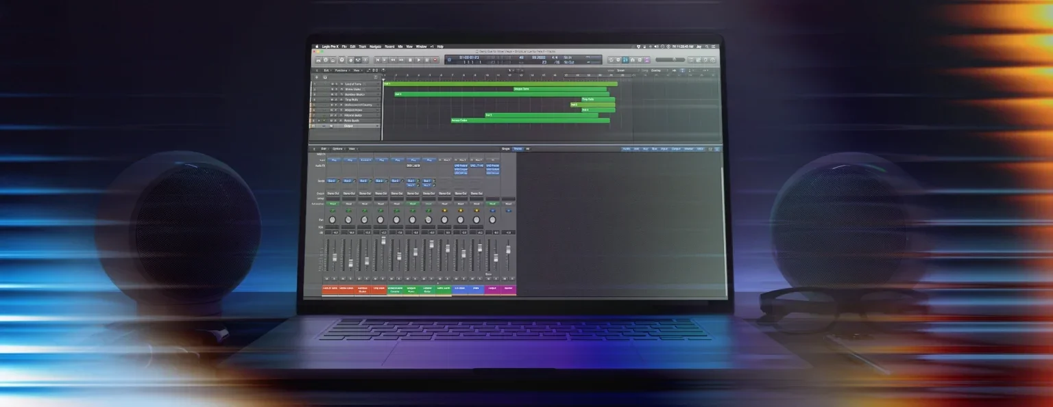 A laptop running Logic Pro with two round speakers besides it
