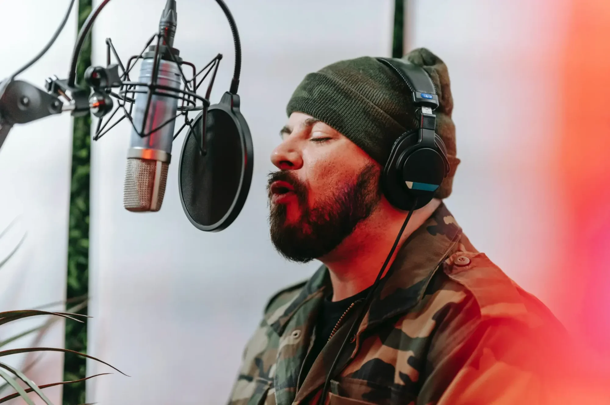 A man wearing headphones singing into a microphone