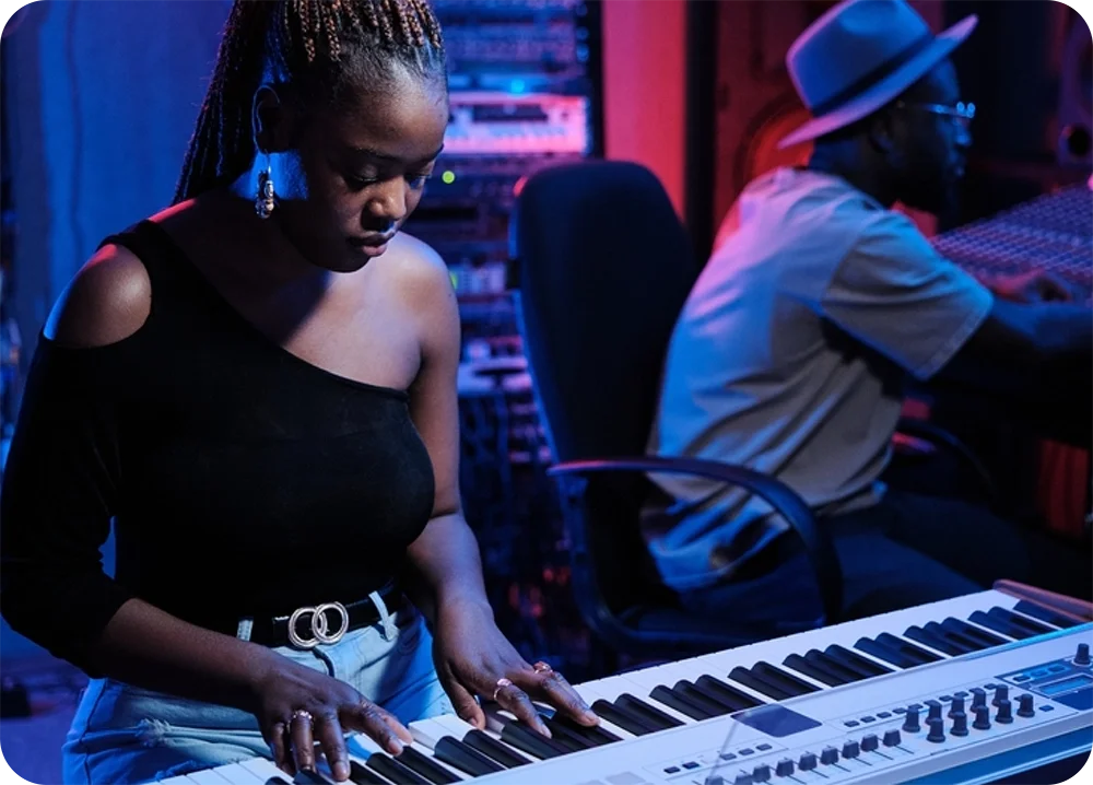 A woman playing the piano in a studio