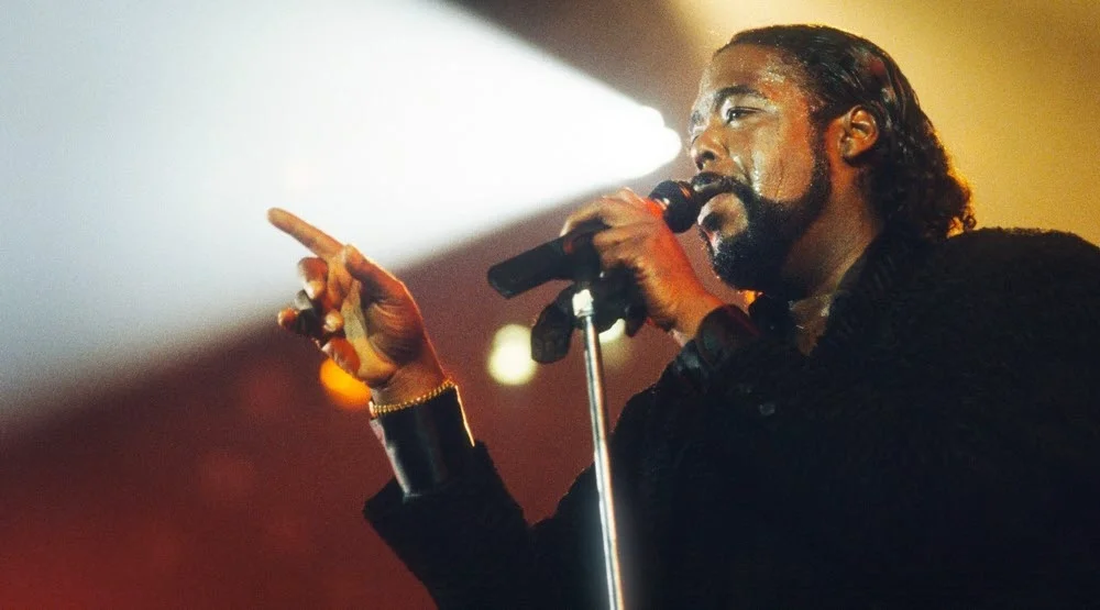 Barry White singing into a microphone
