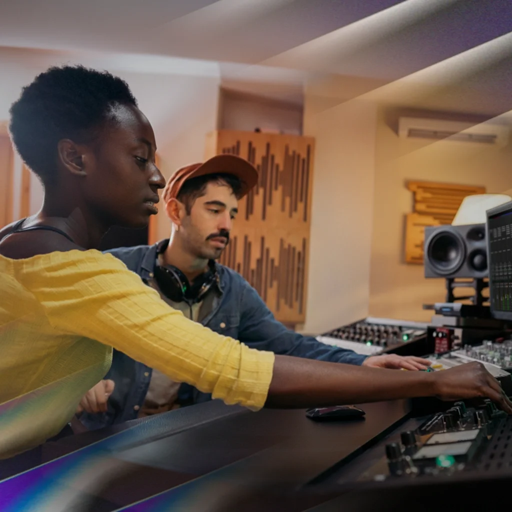 A man and a woman sitting in front of a computer monitor running AutoTune software
