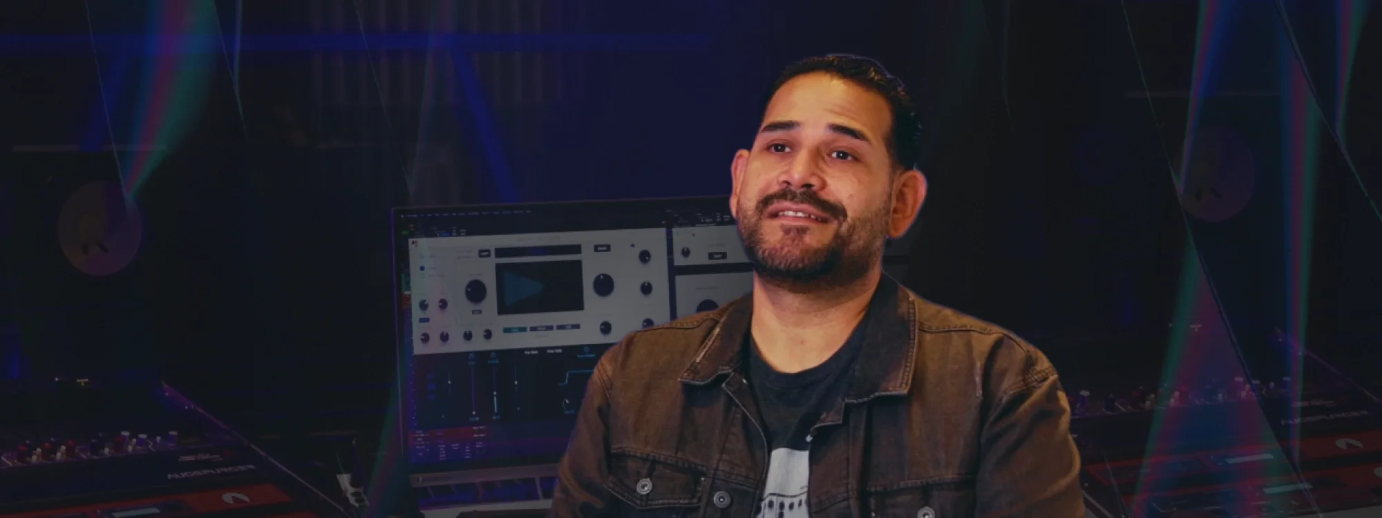 Junior Sanchez sitting in front of a computer monitor running AutoTune