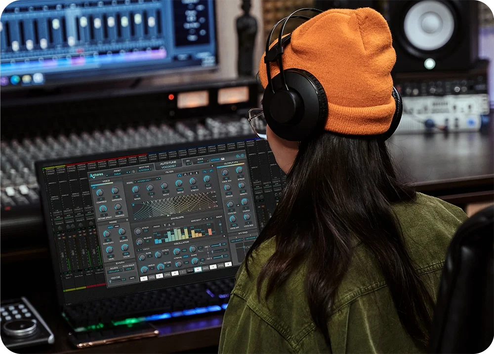 Female wearing headphones in recording engineer room working with Vocodist by AutoTune