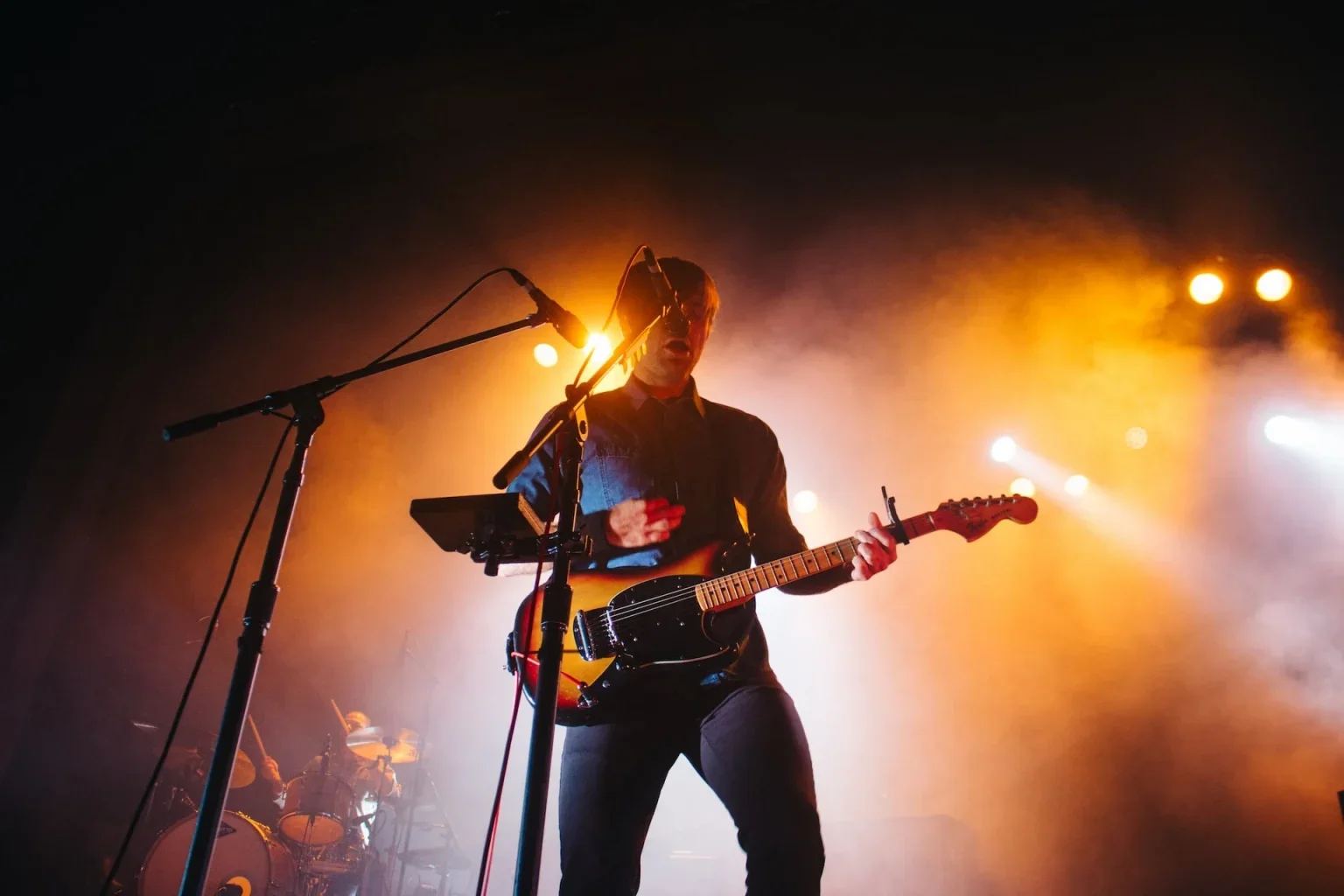 A man playing the guitar on stage