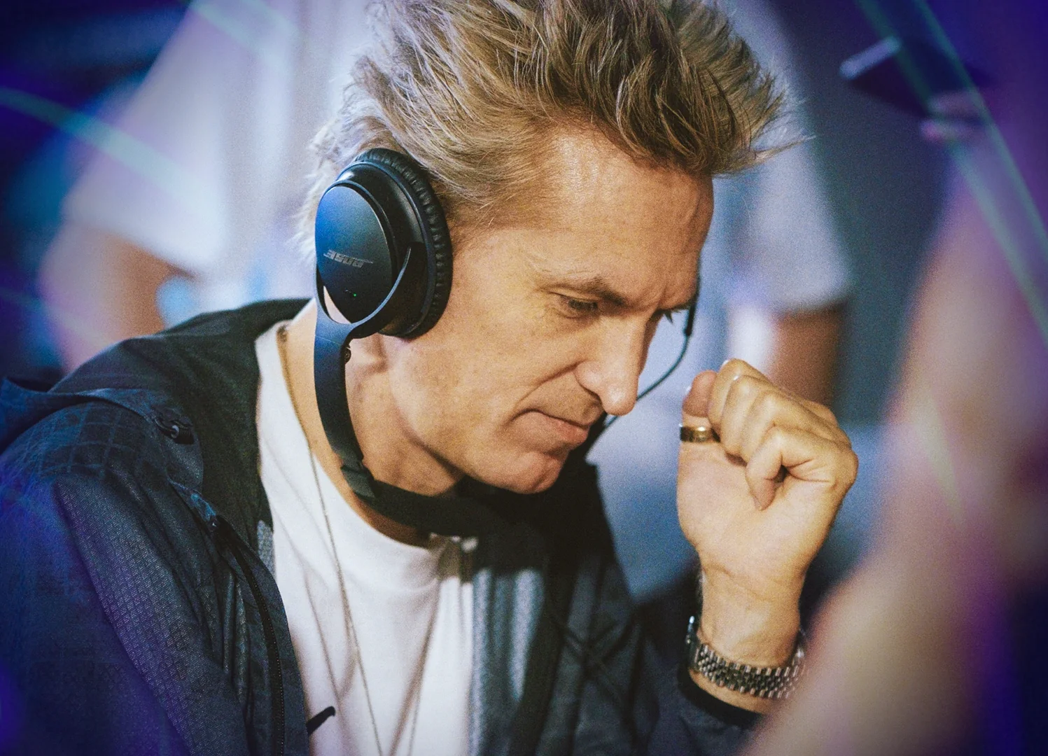 A man wearing headphone looking down at something