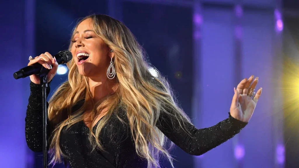 Mariah Carey singing into a microphone