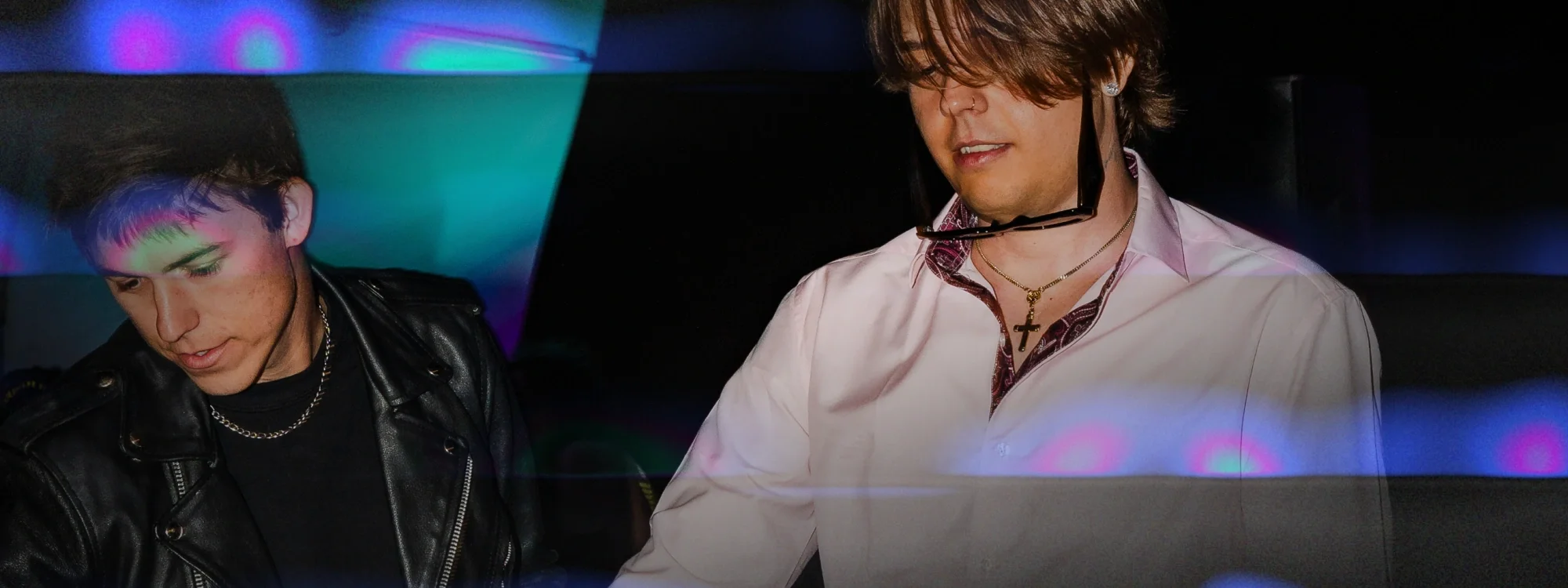Two men standing next to each other DJing