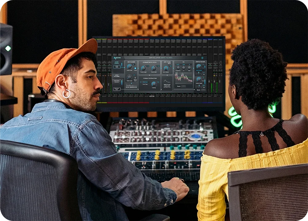 A male and female in a recording engineer room conversing with Articulator by AutoTune is on computer screen