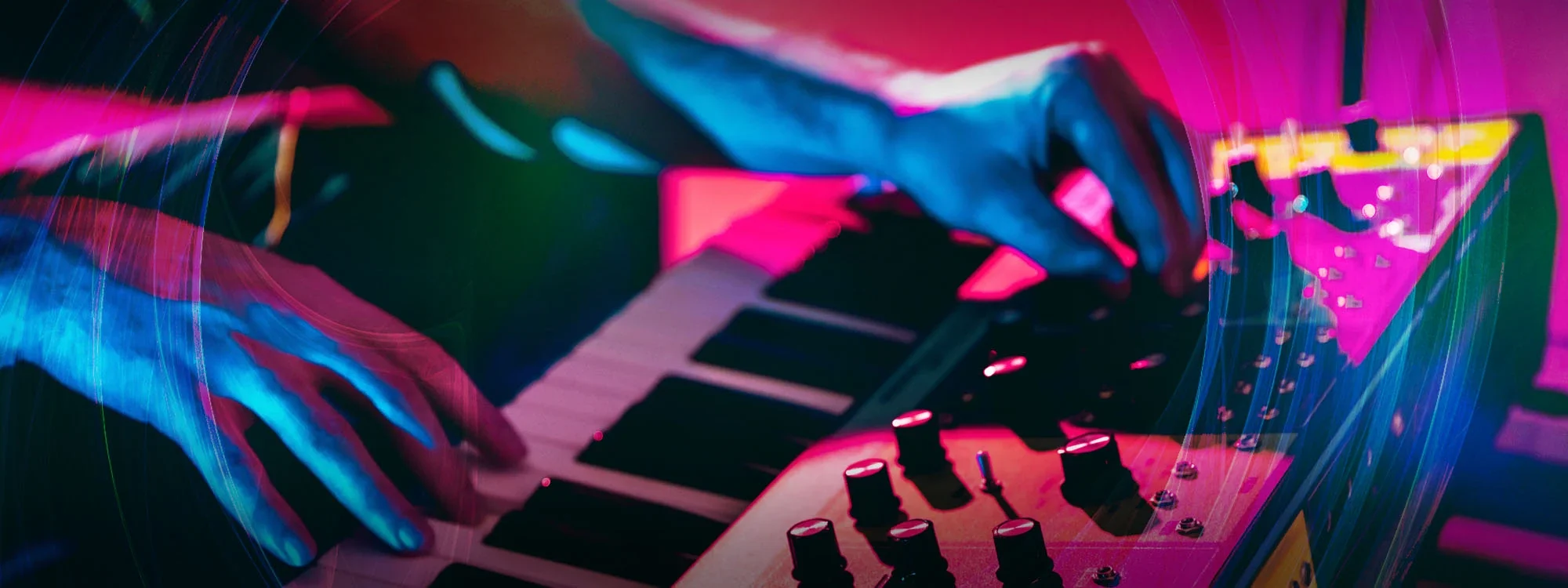 Hands playing the keys and adjusting levels on a midi
