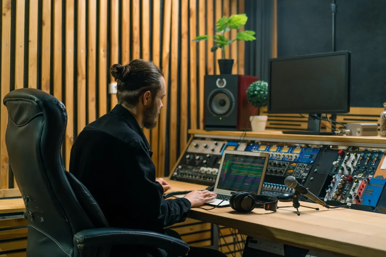 A man sitting at a desk using a laptop