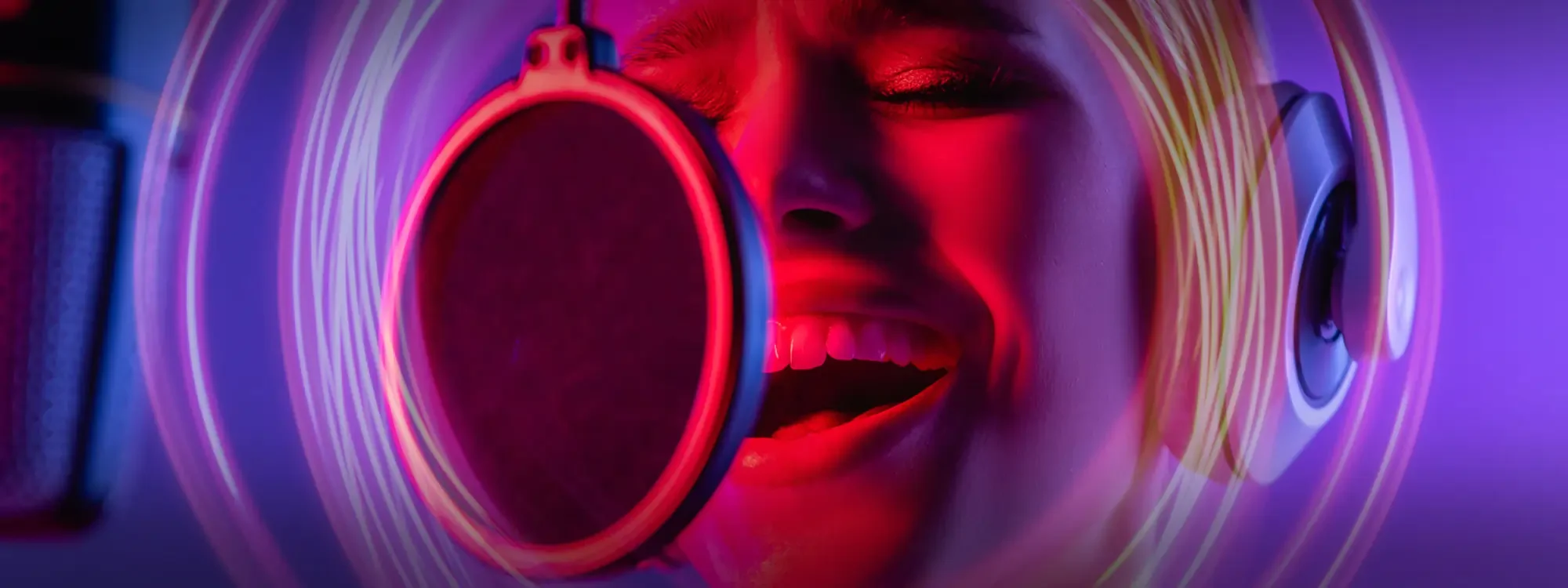 A woman wearing headphones singing into a microphone with purple swirls around her