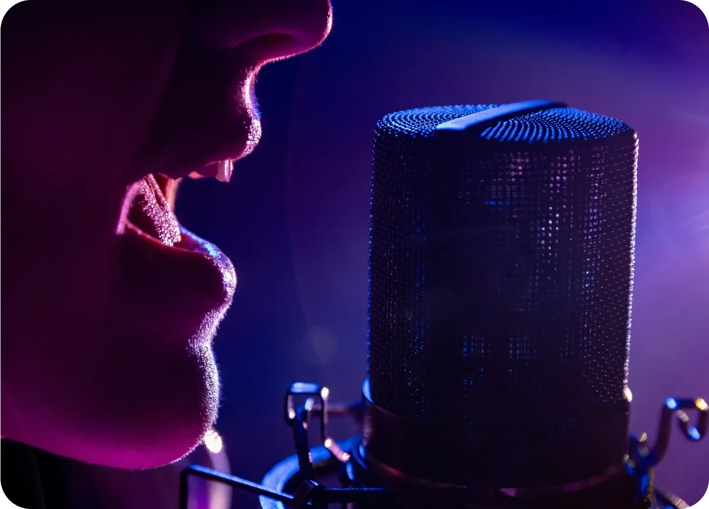 A closeup of a female mouth singing into a microphone
