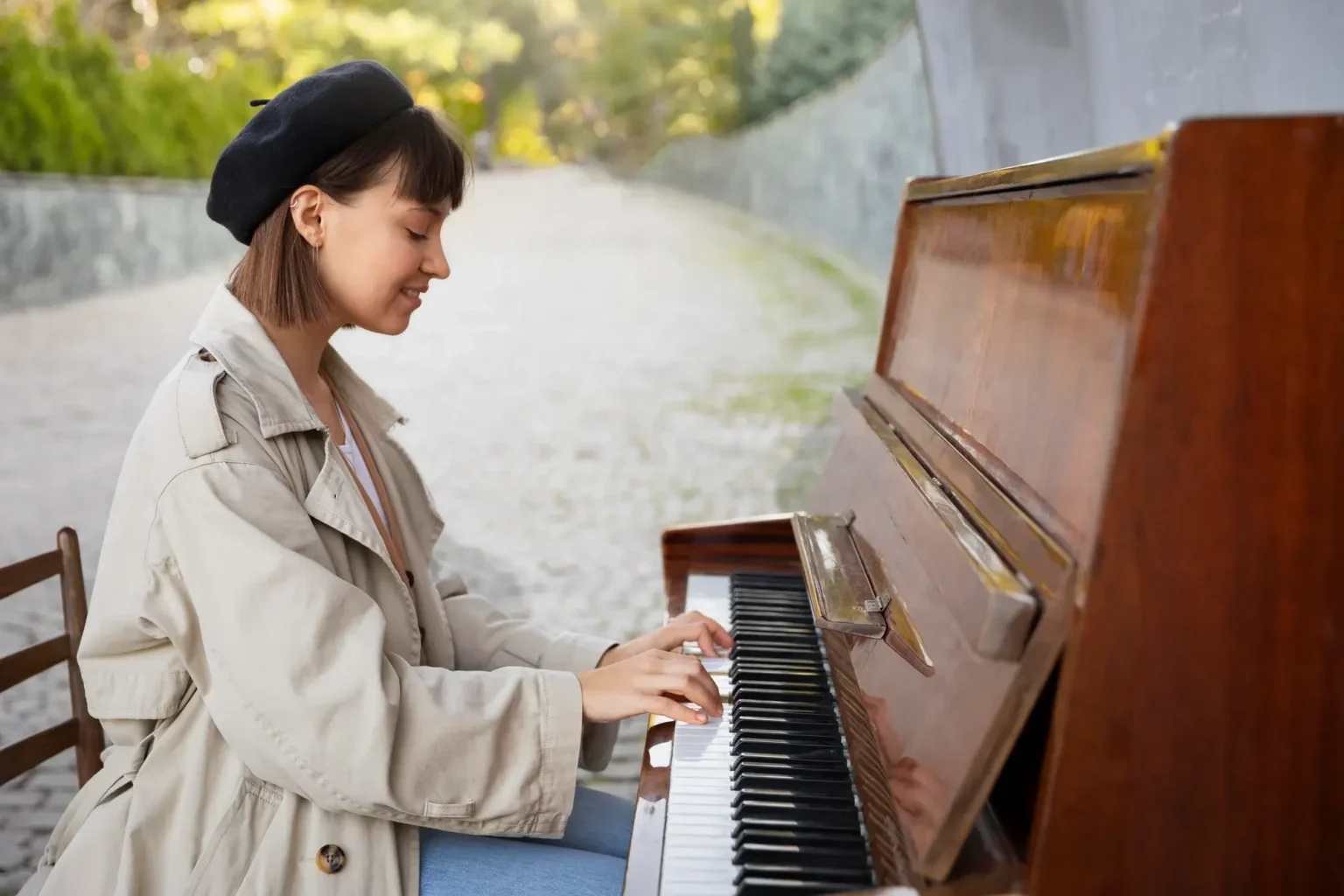 A woman sitting outside and playing the piano