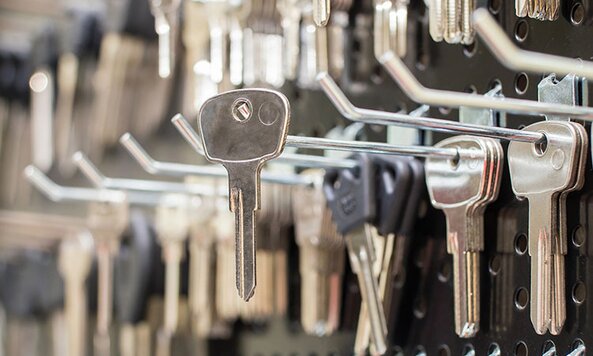 A blank key hangs on a wall.