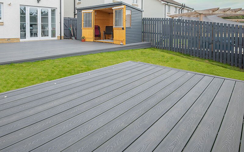 Grey composite decking in a residential backyard.