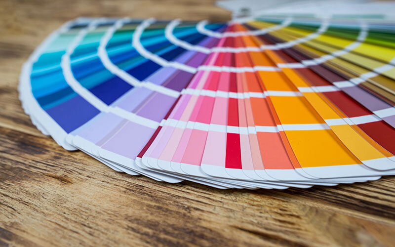 A rainbow of fanned out paint swatches.