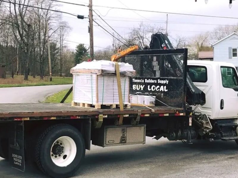 A delivery truck with a small order on a pallet in the bed of the truck at Tionesta Builders Supply.