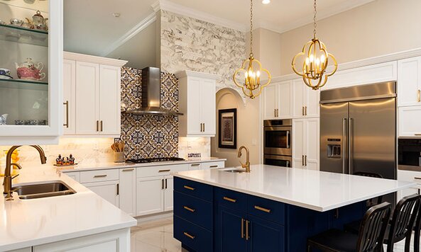 A beautiful kitchen with white cabinets and a blue island. 