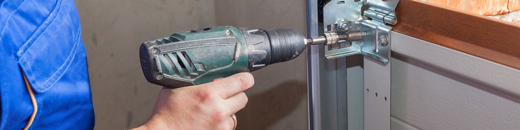 Worker installing a door latch