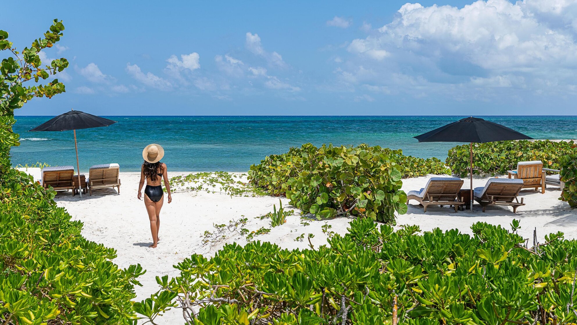 Woman walking on the beach in Riviera Maya, Mexico.