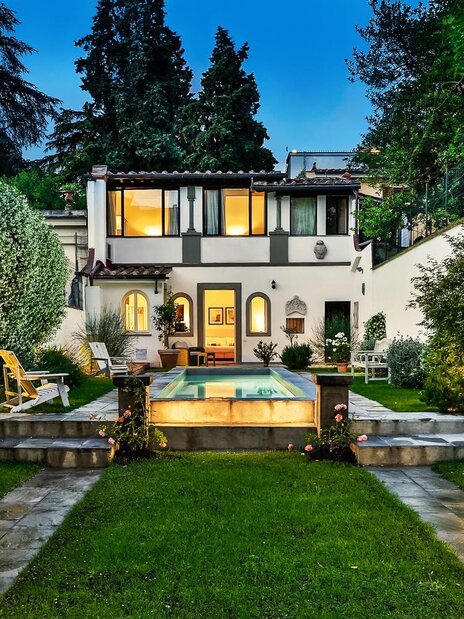 Pool area with blue lounge chairs with matching umbrellas