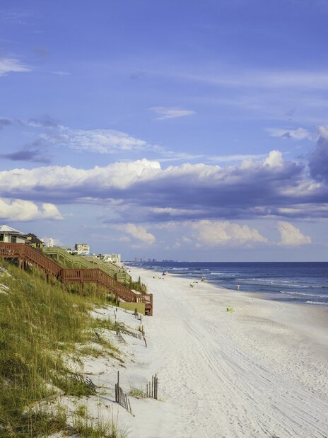 Pool area with blue lounge chairs with matching umbrellas