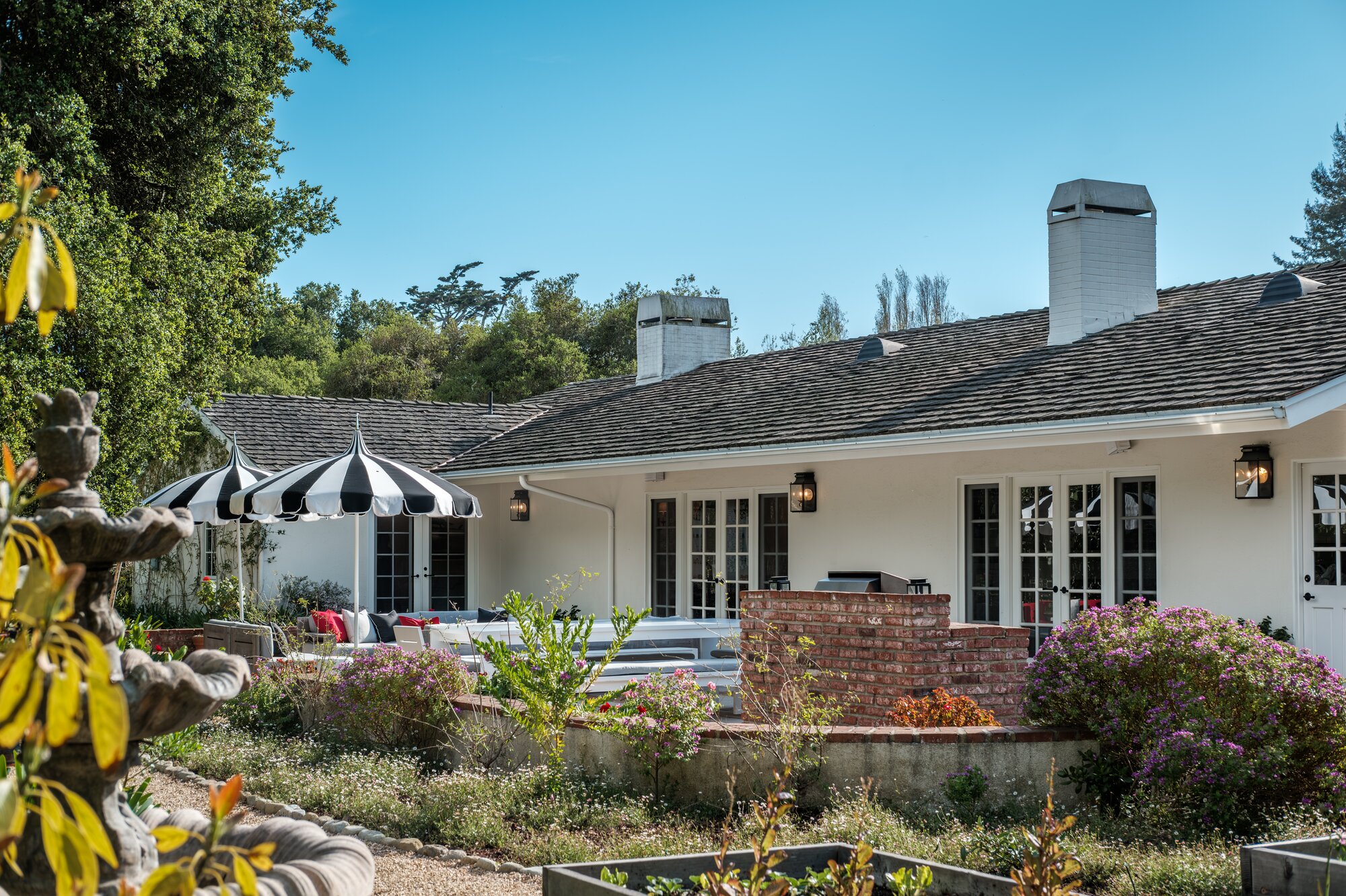 Exterior view of Terrapin home with paved driveway and lots of trees and shrubbery surrounding home