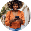 A woman looking at her phone and smiling