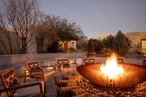 Pool area with blue lounge chairs with matching umbrellas