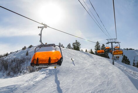 Pool area with blue lounge chairs with matching umbrellas