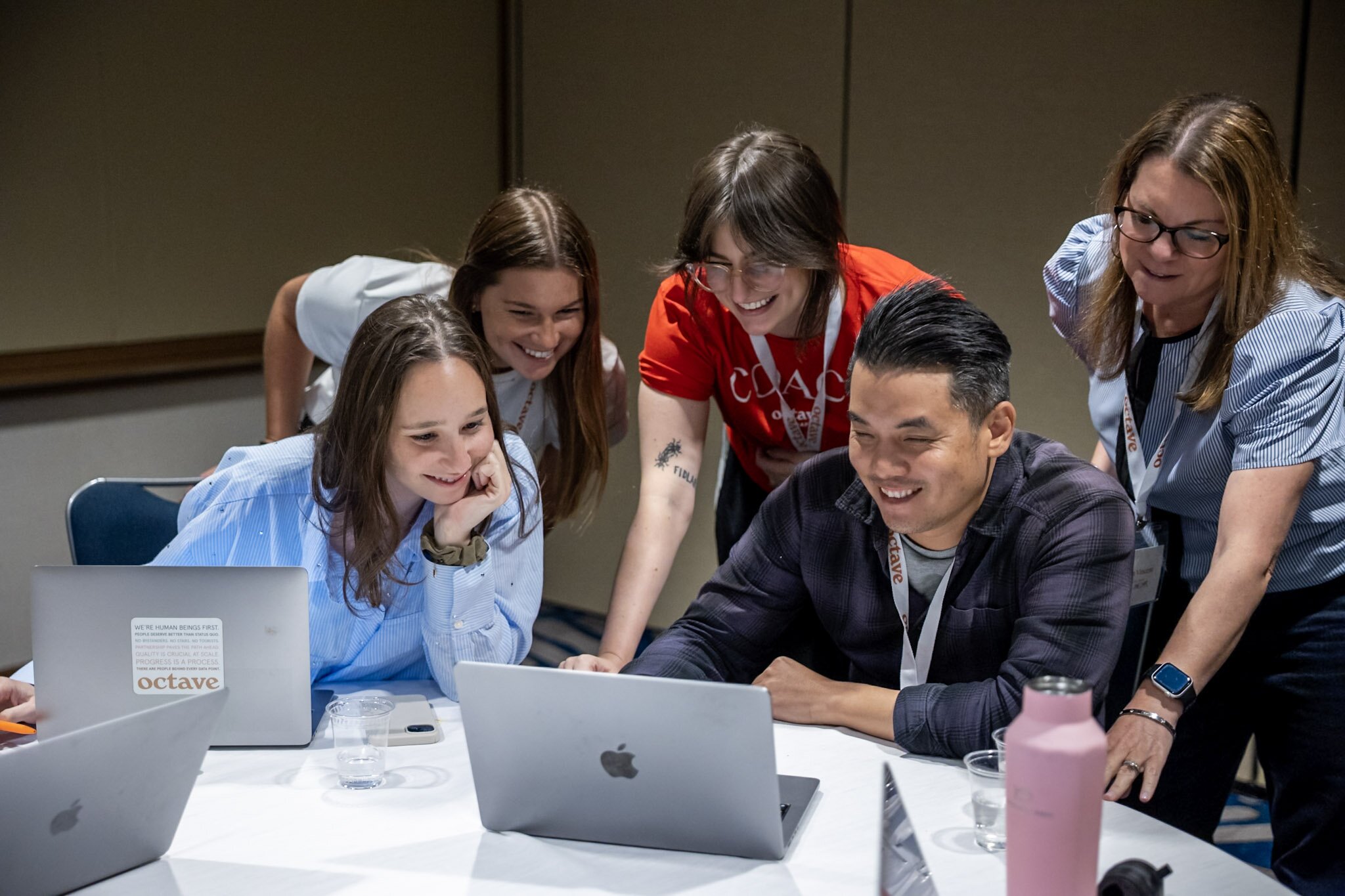 A smiling woman outdoors with a blue sky in the background.