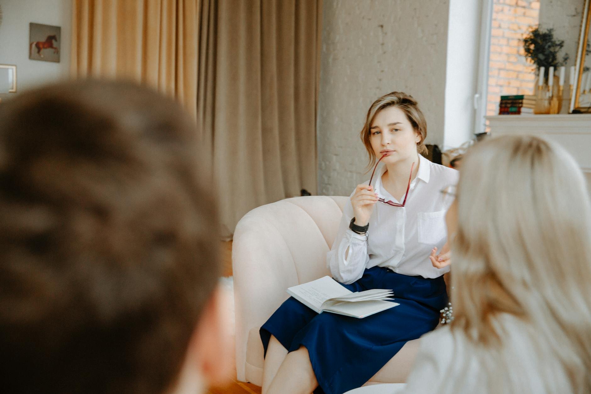 Therapist thinking while taking glasses off