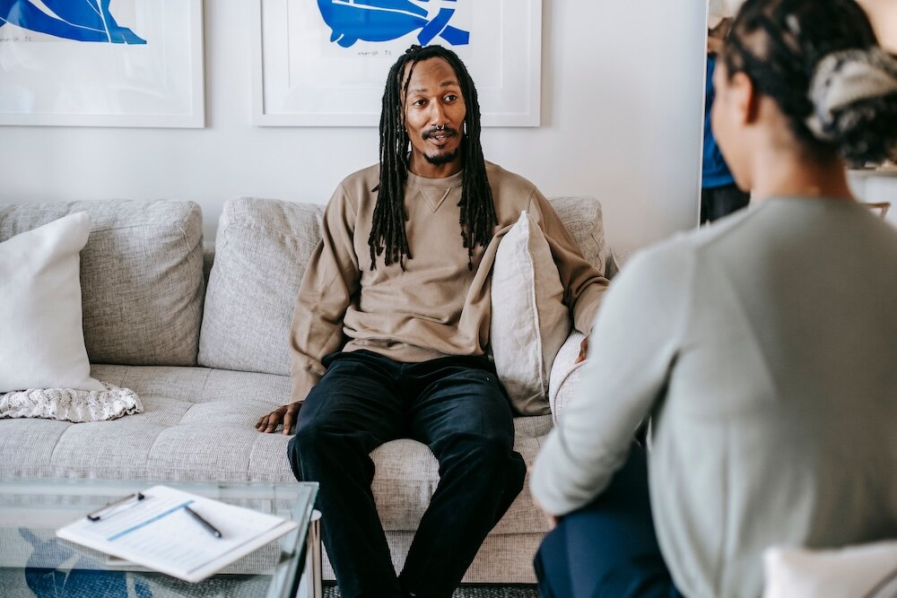 Patient thoughtfully speaking with psychotherapist