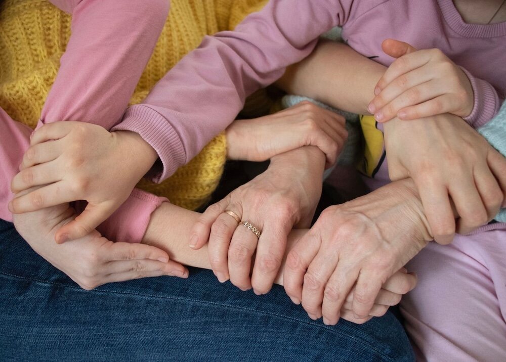 Three pairs of interlaced hands
