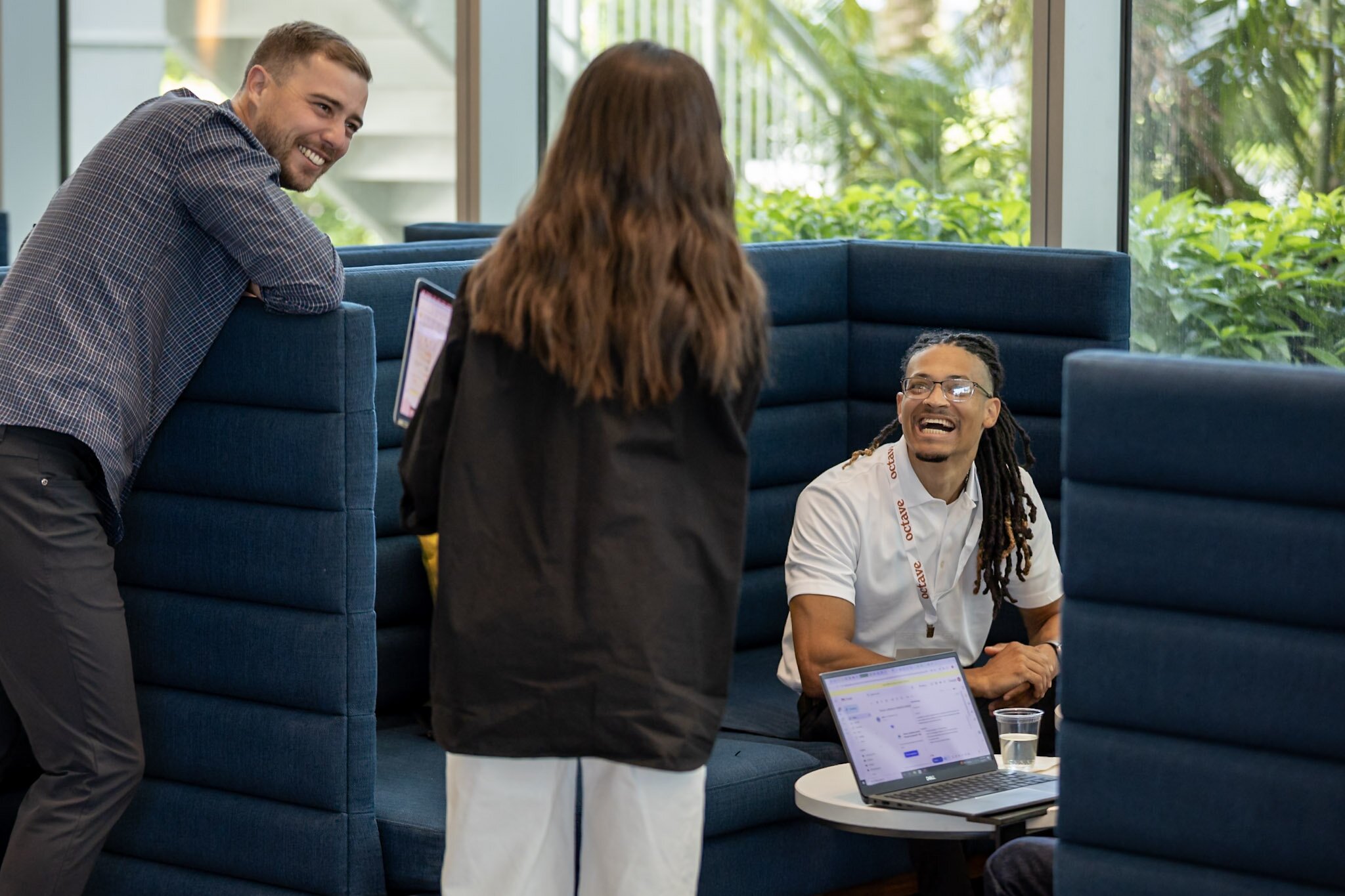 A smiling woman outdoors with a blue sky in the background.