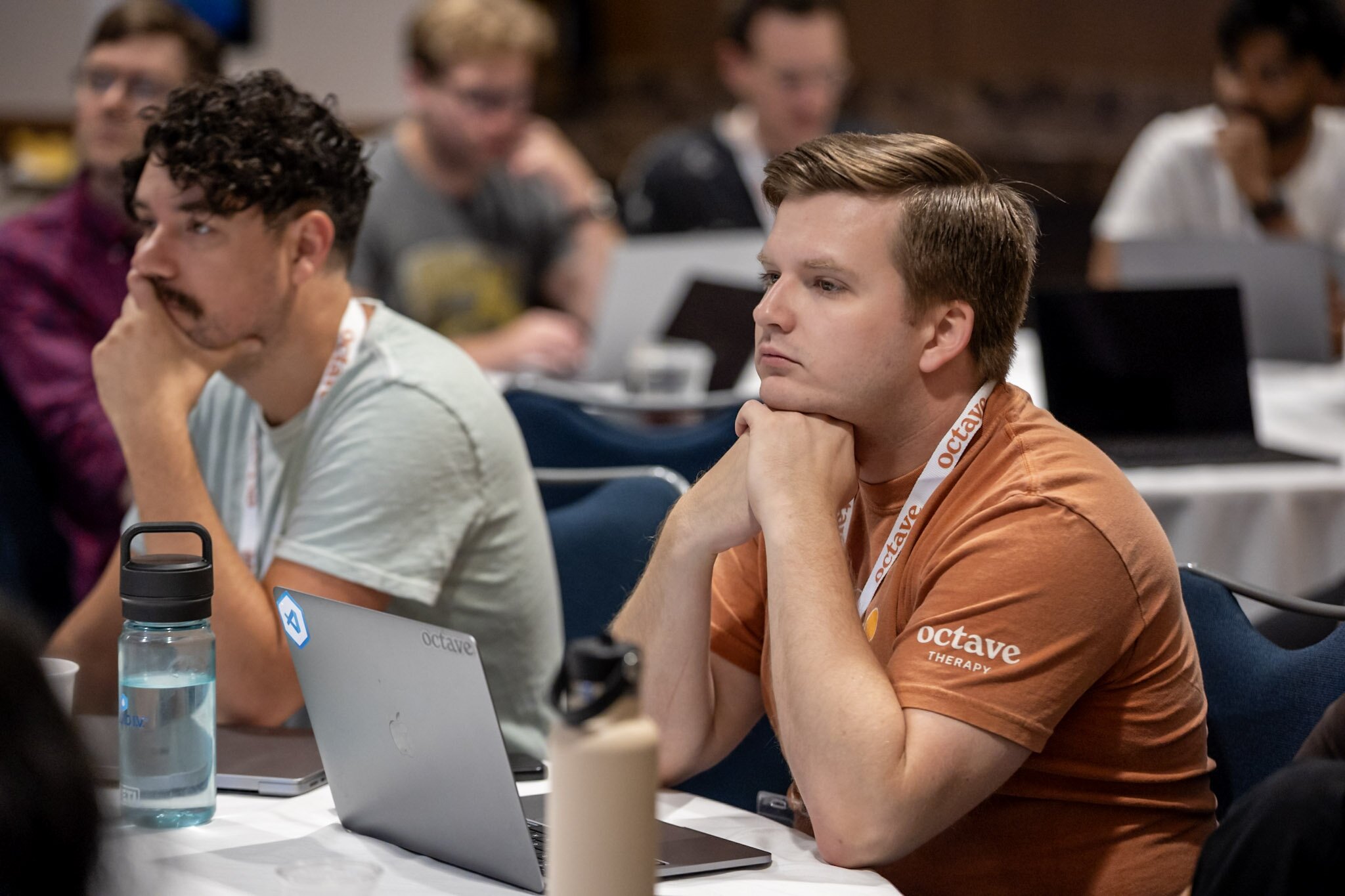 A smiling woman outdoors with a blue sky in the background.